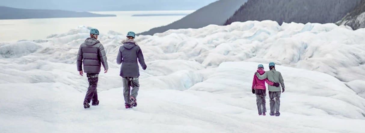 Travelers hiking across an Alaska glacier